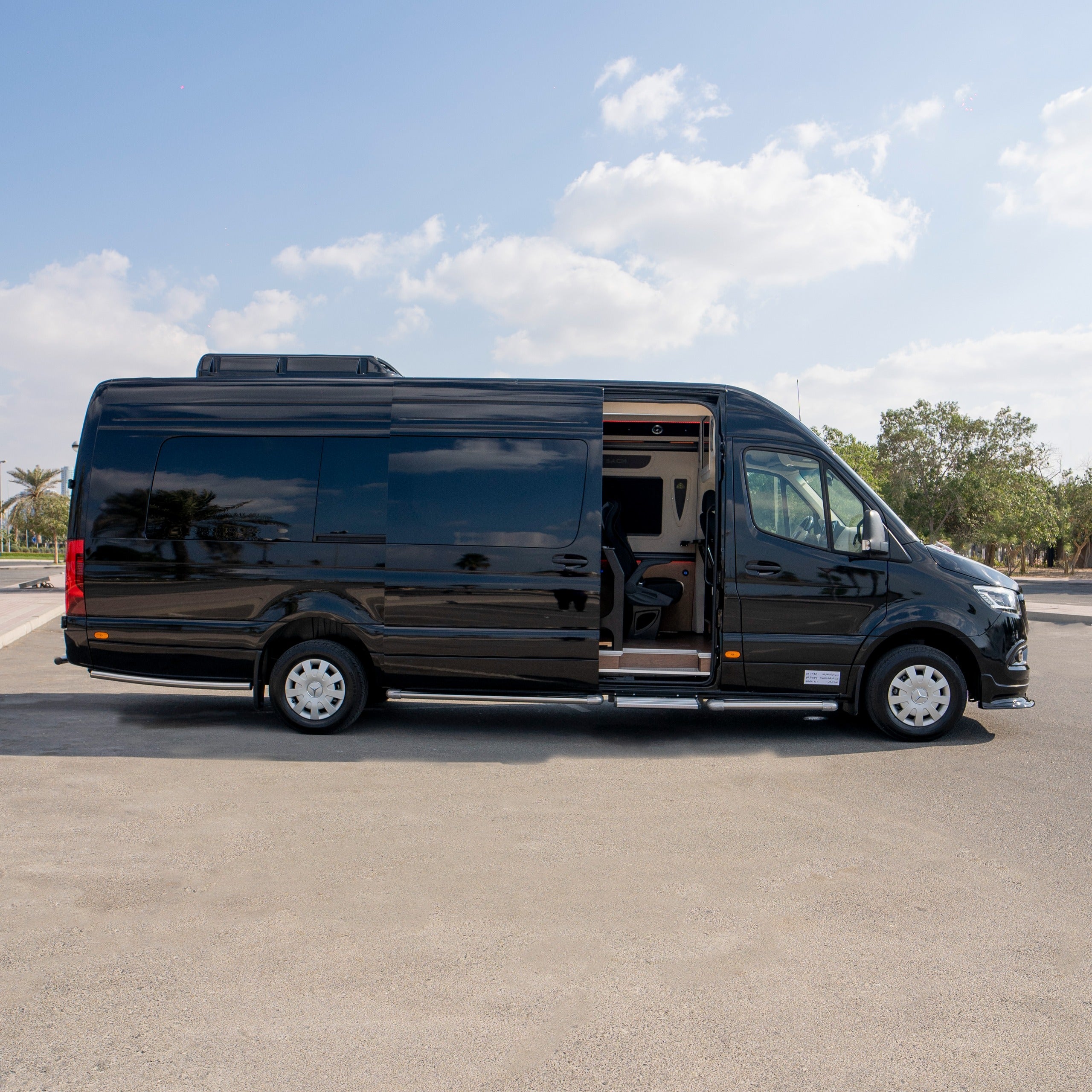 Side view of Maybach Mercedes Sprinter 19-seater van rental in Dubai